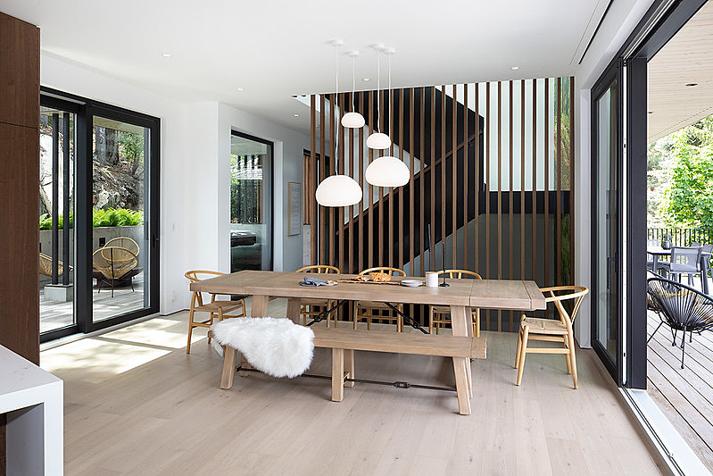 Timber wall slats create a dramatic effect between the steel stairwell and the dining room.